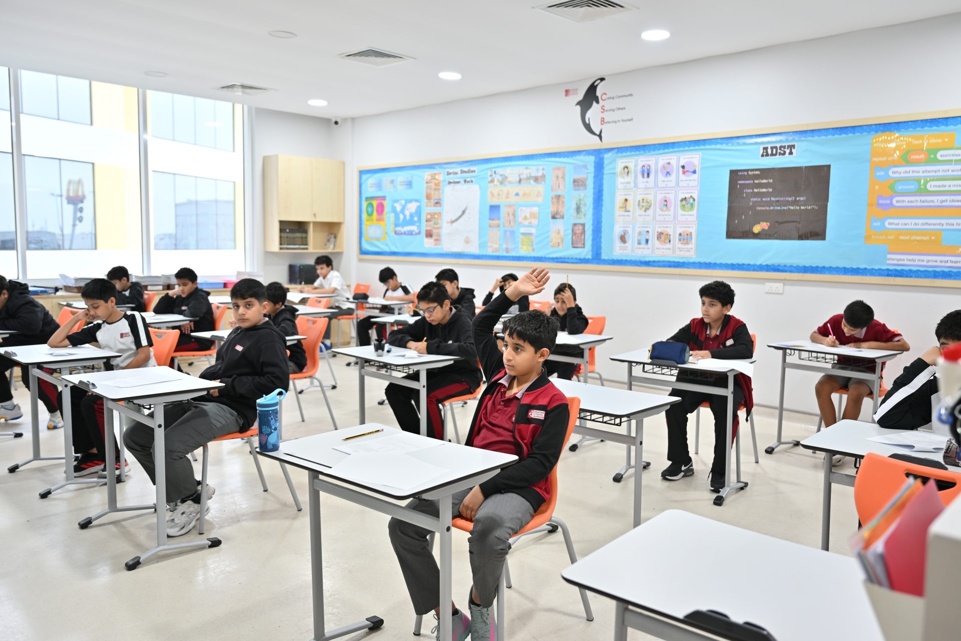 Students working with support and guidance in a classroom at Canadian School Bahrain